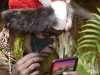 Tribesman putting on makeup at Mt. Hagen Show