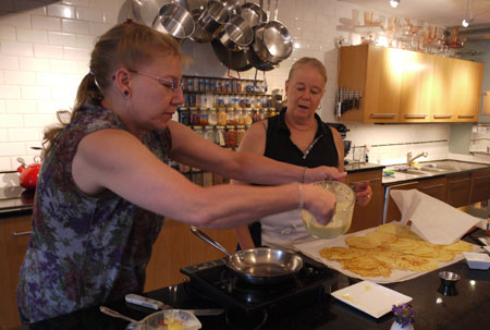 Kim making crepes with Diane looking on at Diane\'s Market Kitchen