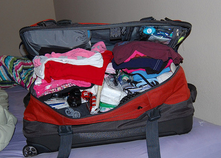 packing clothes in suitcase